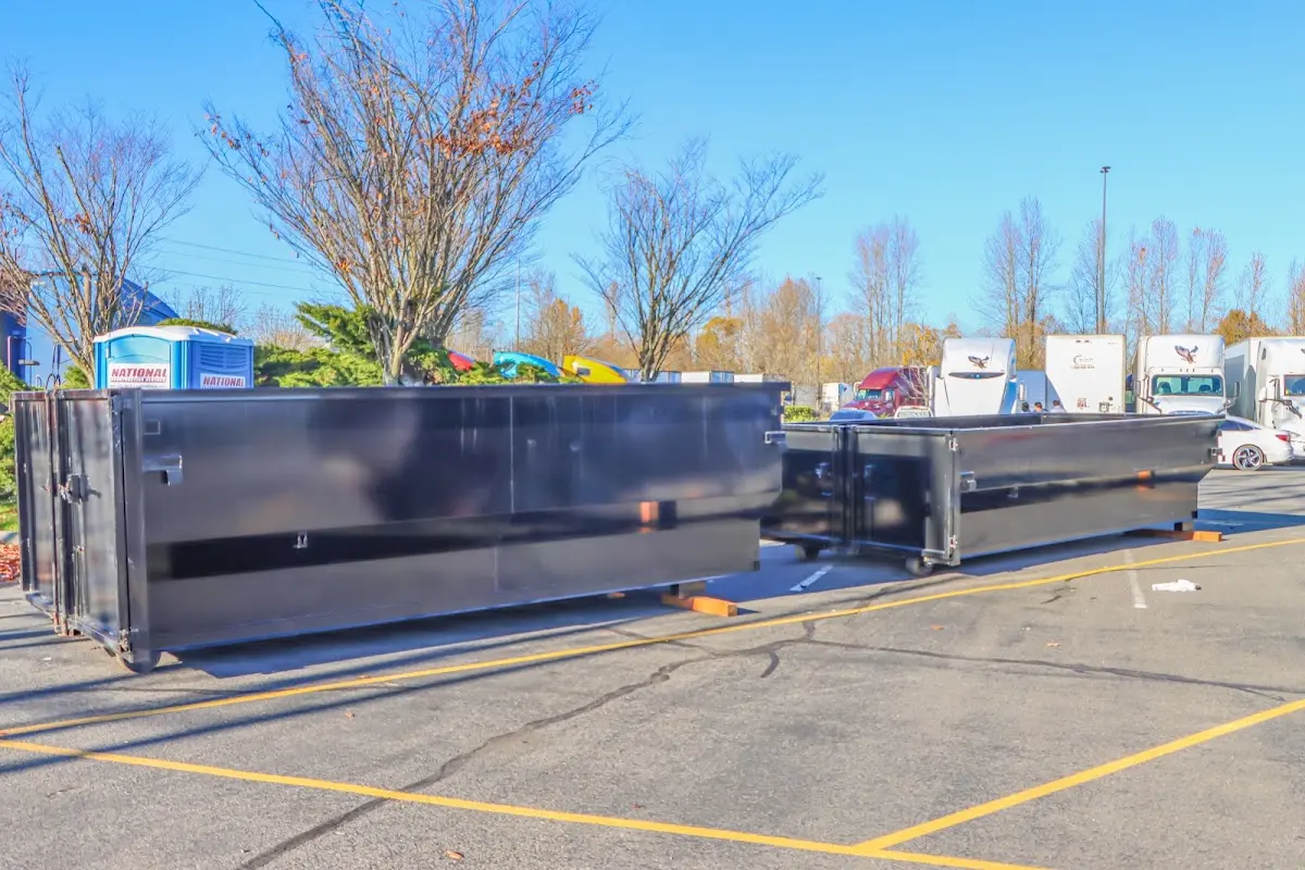 Professional dumpster rental service with roll-off container on residential driveway in The Colony